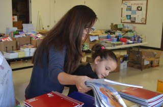 Navy mom Rachael Baranski and nine-year-old Isabella choose school supplies Saturday morning at Naval Air Station Lemoore's "Back to School Brigade."